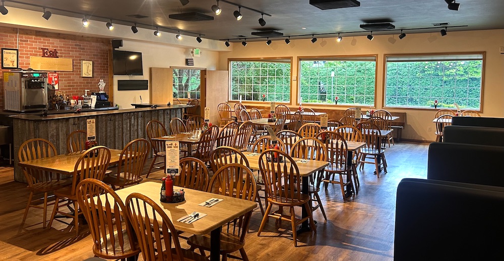 Fanny's banquet room with large windows and warm wood chairs